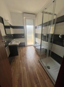 a bathroom with a shower and a toilet and a sink at Welcome Home Quartu Sant'Elena in Quartu SantʼElena