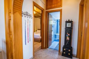 a hallway with a clock and a room with a bed at Reisis Family Residence in Lefkos Karpathou +58 photos