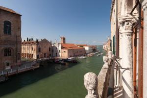 a view of a canal with boats in the water at LUXURY APARTMENT PESARO PAPAFAVA in Venice