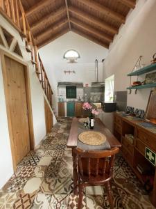 a kitchen with a wooden table in a room at Sunset Nest in Ponta Delgada