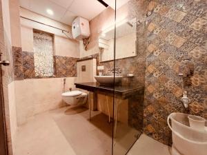 a bathroom with a sink and a toilet at Pinerock Resort, Mussoorie ! Luxury Rooms ! Mountain View ! Open Terrace ! Cafe in Mussoorie