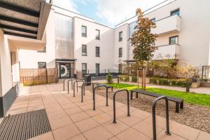 a row of benches in front of a building at Apartament Chmielna Loft in Krakow