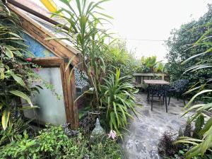 a garden with a table and some plants at Sunset Nest in Ponta Delgada