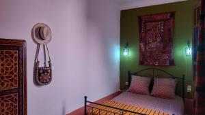 a bedroom with a bed and a picture on the wall at Logement entier riad Dar Sana in Marrakesh