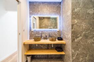 a bathroom with a sink and a mirror at Charmante longère proche des côtes de granit rose in Lannion