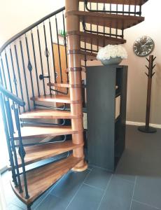 a spiral staircase in a house with a vase of flowers at B&B At Forty Three in Vatsker