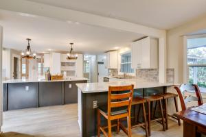 a kitchen with white cabinets and a table and chairs at Eugene Vacation Home 2 Mi to University of Oregon in Eugene