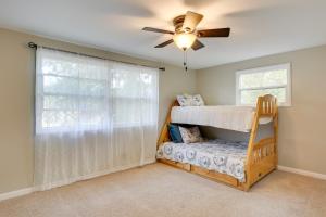 a bedroom with a bunk bed and a ceiling fan at Eugene Vacation Home 2 Mi to University of Oregon in Eugene