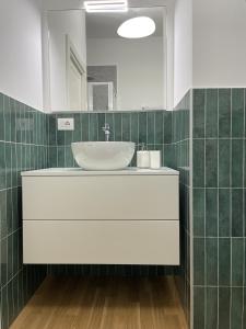 a bathroom with a sink and a mirror at MILA by The Blue Twins apartments Milano in Milan