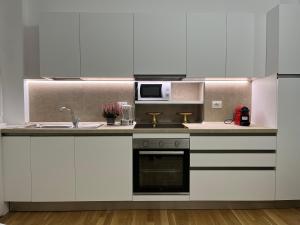 a kitchen with a sink and a microwave at MILA by The Blue Twins apartments Milano in Milan