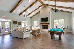 a living room with a pool table in it at Luxe Jekyll Island Home with Beach and Pool Access in Jekyll Island