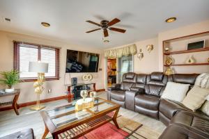 a living room with leather furniture and a ceiling fan at Lovely Ocean Gate Home Less Than 1 Mi to Beach! in Ocean Gate