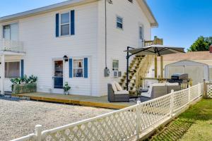 a white house with a white fence at Chincoteague Apartment with Deck Walk to Waterfront in Chincoteague