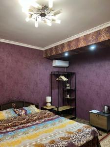 a bedroom with a bed and a ceiling fan at Golden Rose in Chişinău