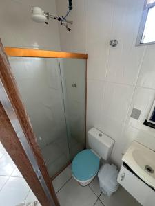 a bathroom with a shower and a toilet and a sink at Casa aconchegante in Belo Horizonte