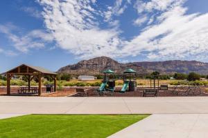 a park with a playground with mountains in the background at Jasper tiny home with private hottub in Apple Valley