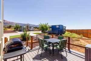 a patio with a table and chairs and a grill at Jasper tiny home with private hottub in Apple Valley