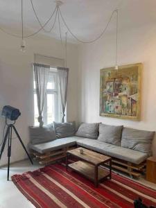 a living room with a couch and a table at Par Par Apartman in Budapest