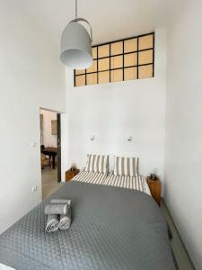 a bedroom with a bed with two towels on it at Par Par Apartman in Budapest