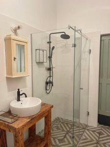 a bathroom with a sink and a glass shower at Par Par Apartman in Budapest