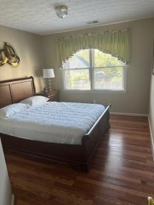 ein Schlafzimmer mit einem großen Bett und einem Fenster in der Unterkunft Whitfield Manor in Lexington