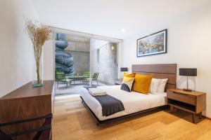 Ένα ή περισσότερα κρεβάτια σε δωμάτιο στο New Apartments La Condesa by VIATO
