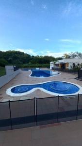 two swimming pools on top of a building at Beautiful and cozy apartment in Villeta +9 photos