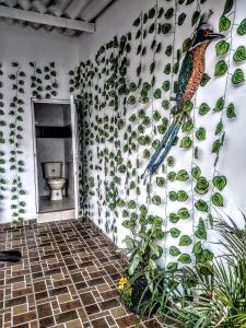 a bathroom with a bird on a wall with plants at My second house in Manizales