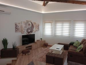 a living room with a couch and a flat screen tv at Mirador Porta da Vila, Noia in Noya