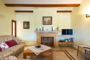 a living room with a couch and a fireplace at Villa Llobell - Plusholidays in Moraira