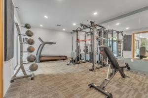 a gym with several exercise equipment in a room at Chic 1-bed in Vibrant Optimist Park apts in Charlotte