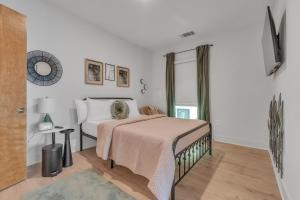 a white bedroom with a bed and a window at Chic 1-bed in Vibrant Optimist Park apts in Charlotte