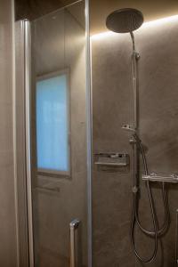 a bathroom with a shower with a glass door at Balibà Ride & Relax in Castione Andevenno
