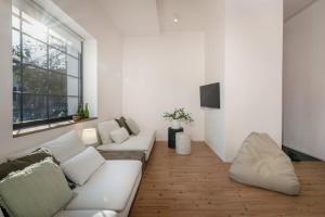 a living room with a white couch and a window at Ateliér v raji in Spišské Tomášovce