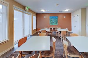 a classroom with tables and chairs and windows at Piers At Pike in Seattle