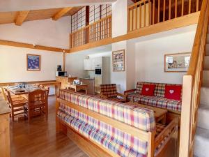 a living room with a couch and a table at Duplex spacieux aux pieds des pistes avec parking et balcon - FR-1-344-732 in Saint-Martin-de-Belleville