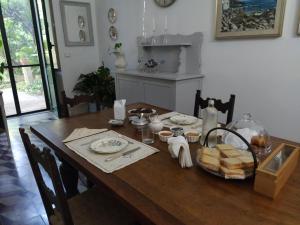 a wooden table with food on it in a kitchen at Aricelle Speziali in Specchia Gallone