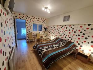 a bedroom with a bed with polka dots on the wall at Évasion Tranquille entre Briey et Longuyon - Chambre d'Hôtes sur 5 Hectares - FR-1-584-288 in Lantéfontaine +6 photos