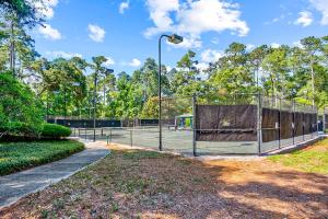 a tennis court with a net on a tennis court at Tidewater Dream in North Myrtle Beach