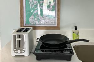 a frying pan on top of a stove with a toaster at Capri 109 in Marco Island