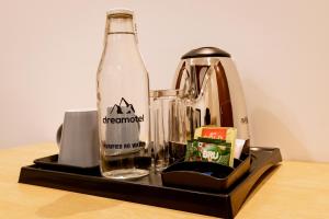 a bottle of coke and a blender on a table at Dreamotel Luxury Suites in Kanjikode