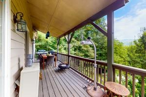 a screened in porch with a view of the mountains at Villa Zara Mountain Retreat in Banner Elk