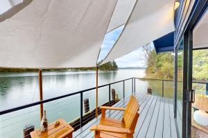 a porch with a bench and a view of the water at Cedrona Cove Cottage in Fox Island