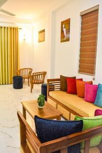 a living room with a couch and a table at TwinsTop Villa in Minuwangoda