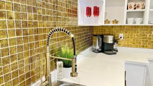 a kitchen with a sink with a faucet at Casa Roja - 1block2beach - Las Playas in Tijuana