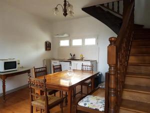 a kitchen and dining room with a wooden table and chairs at Maison centre-ville calme avec jardin in Lons-le-Saunier