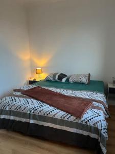 a bedroom with a bed in a white room at Appartement 2 chambres narbonne in Narbonne +2 photos
