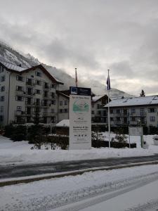 a sign in the snow in front of a resort at Duplex résidence spa Mont-Blanc in Vallorcine