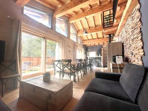 a living room with a couch and a table at Chalet le petit Nicolas, jacuzzi, vue Mont Blanc in Chamonix-Mont-Blanc