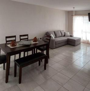 a living room with a couch and a table and chairs at Residencial Aeropuerto in Veracruz